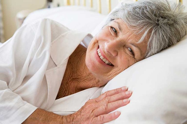 woman lying bed smiling woman lying bed smiling