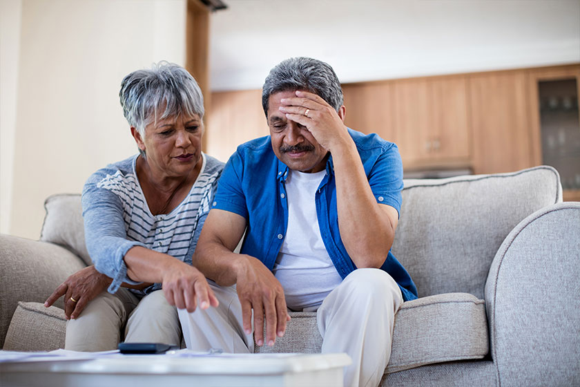 Worried senior couple discussing their bills Worried senior couple discussing their bills