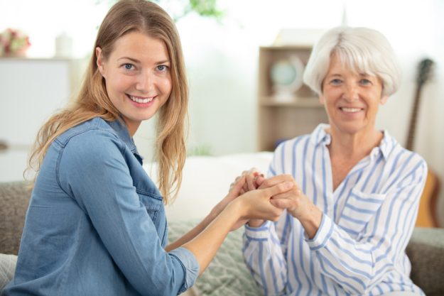 positive smiling old grandma mother and young adult granddaughter