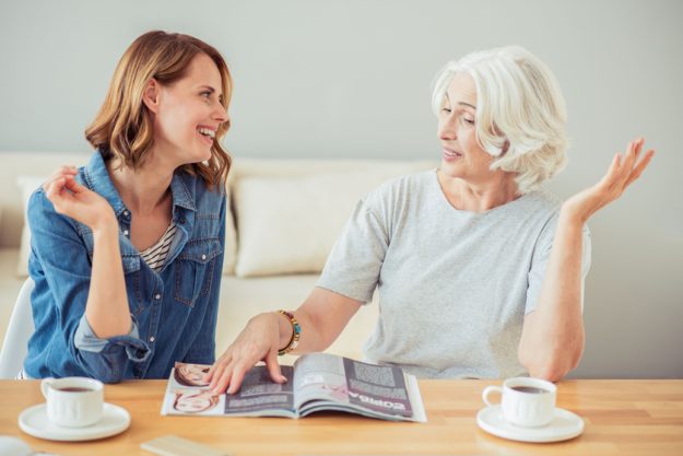 Positive adult woman and her mother talking Positive adult woman and her mother talking