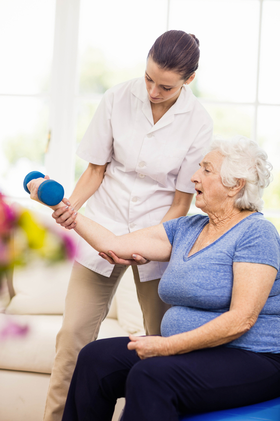 Physiotherapist taking care of sick elderly patient at home Physiotherapist taking care of sick elderly patient at home