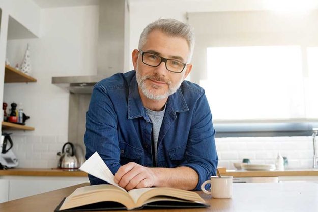 Man reading book home modern kitchen