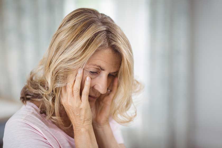 Tense senior woman sitting in bedroom Tense senior woman sitting in bedroom