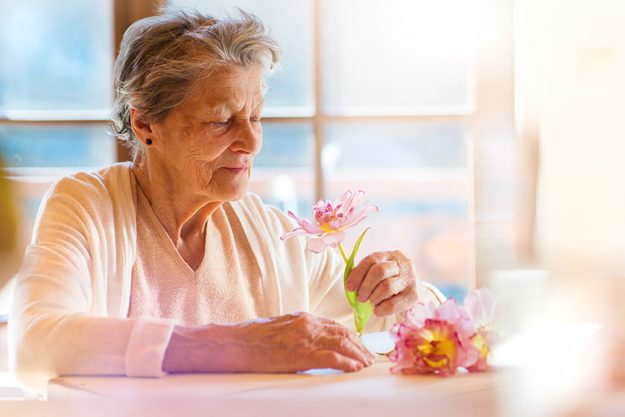Woman holding a pink flower
