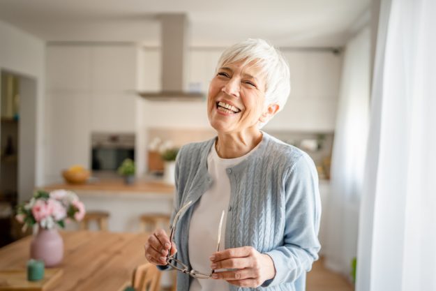 Close up portrait of one senior woman with short hair happy smile