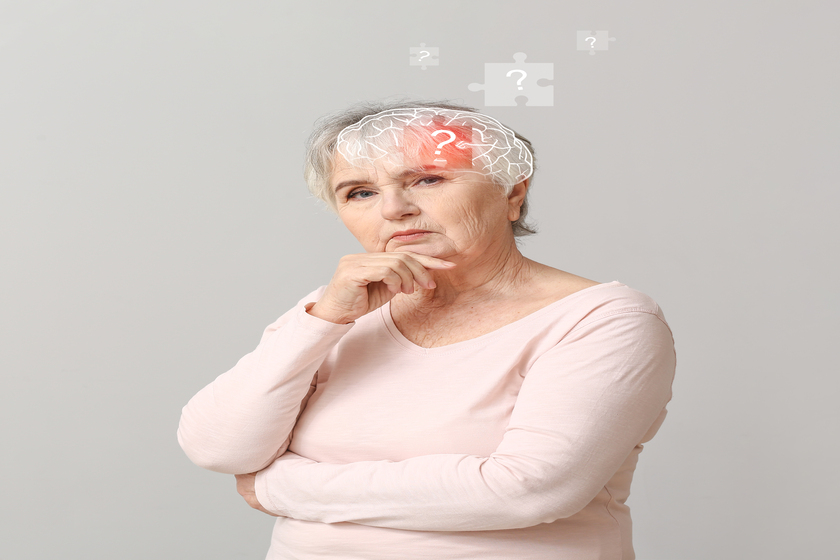 Elderly woman suffering from mental disability on grey background