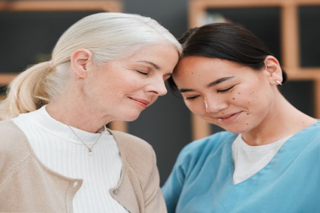 Nursing home friendship, senior woman and nurse with a smile from retirement and support. Bonding, healthcare and Asian caregiver feeling happy from elderly care and medical job with a elderly female Nursing home friendship, senior woman and nurse with a smile from retirement and support. Bonding, healthcare and Asian caregiver feeling happy from elderly care and medical job with a elderly female
