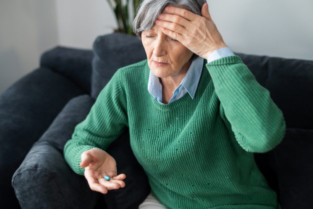 Senior lady experiencing a terrible headache