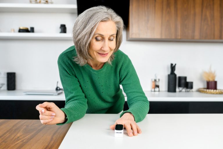 Woman using oximeter for measures the oxygen saturation Woman using oximeter for measures the oxygen saturation