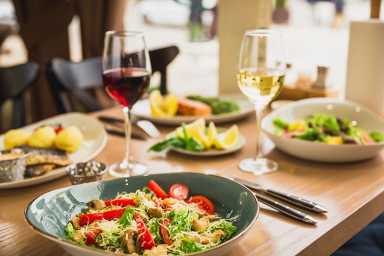 Festive dinner tasty salads fish dishes glass wine healthy food