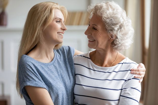 Headshot portrait of adult granddaughter and elderly grandmother