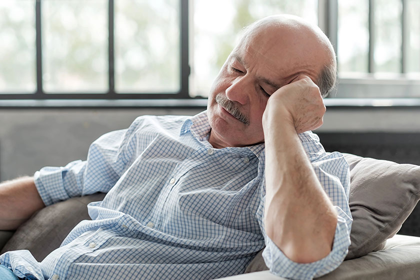 Man sleeping on couch taking afternoon nap at the living room Man sleeping on couch taking afternoon nap at the living room