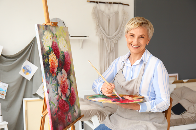 Mature female artist painting picture workshop Mature female artist painting picture workshop