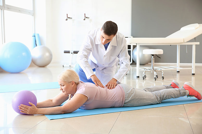 Physiotherapist working with mature patient in rehabilitation center Physiotherapist working with mature patient in rehabilitation center