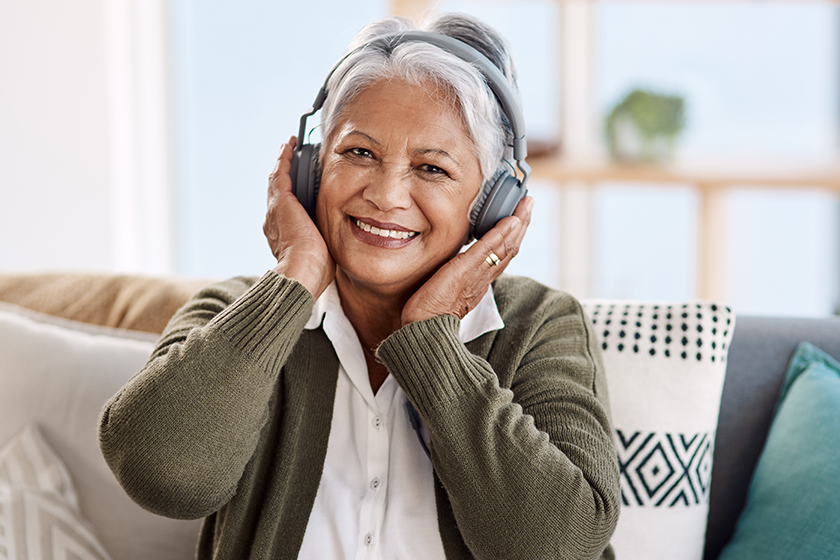 Portrait house old woman headphones streaming music retirement audio listening Portrait house old woman headphones streaming music retirement audio listening
