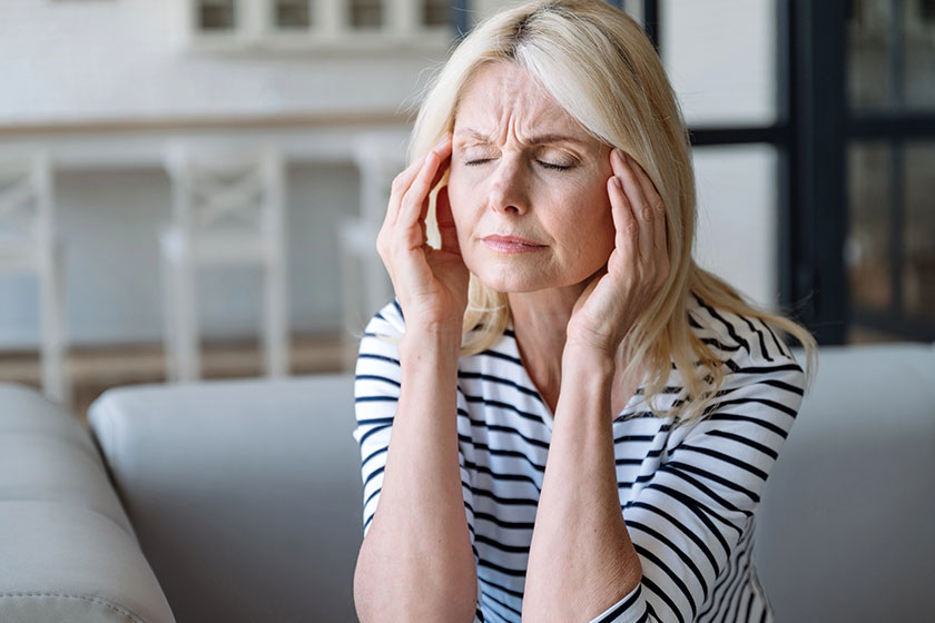 Portrait mature woman touching massaging temples suffering severe head ache Portrait mature woman touching massaging temples suffering severe head ache