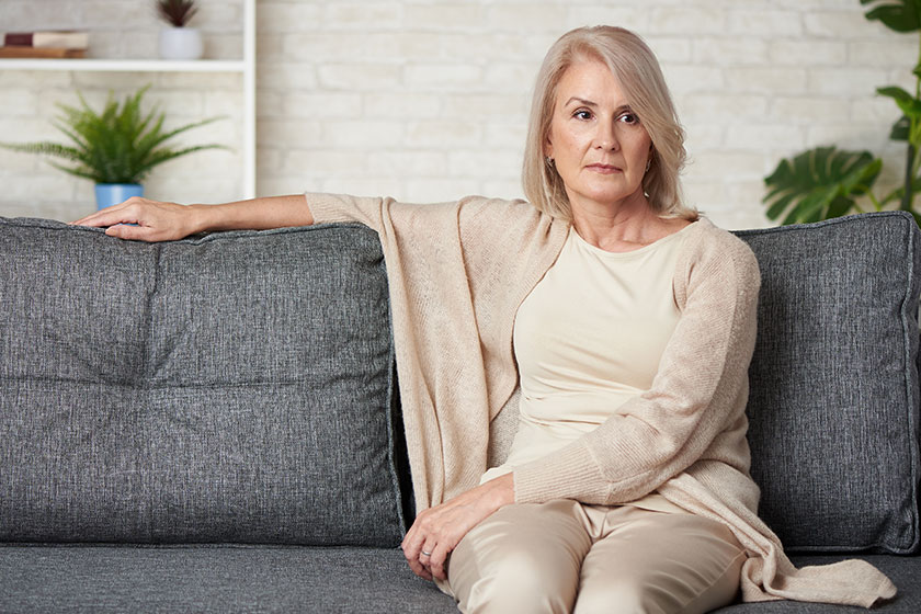 Portrait sad older woman sitting sofa home Portrait sad older woman sitting sofa home