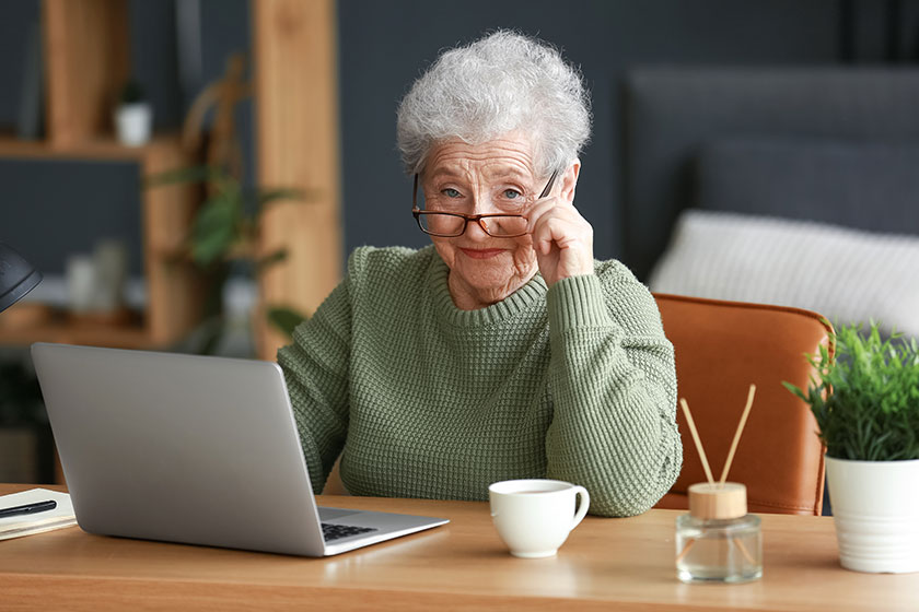 Senior woman laptop sitting office