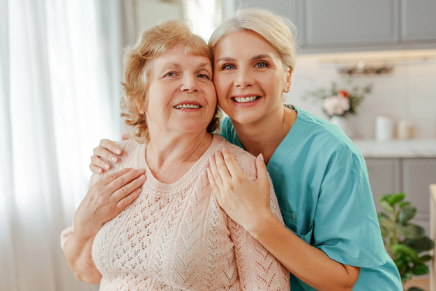 nurse blue scrubs comforts elderly woman