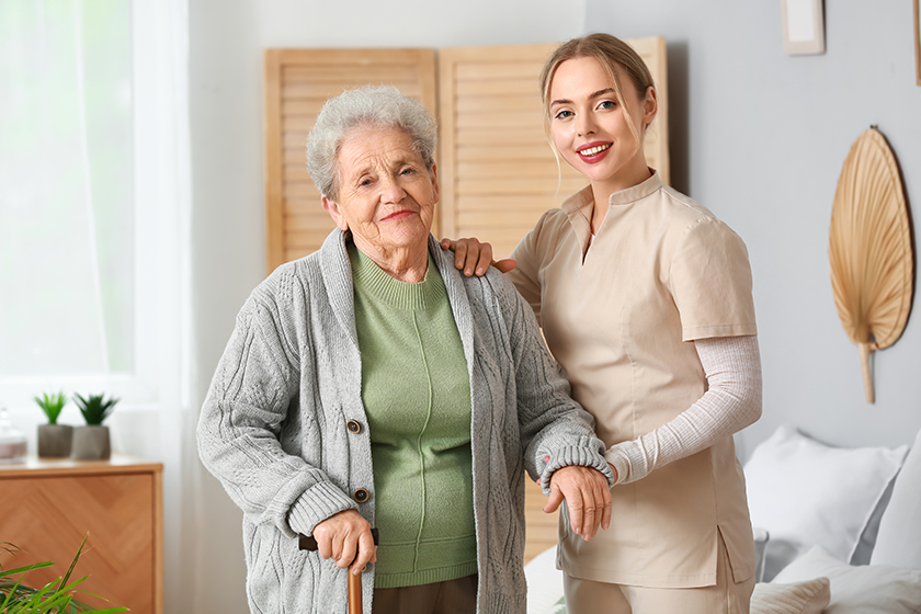 young caregiver helping senior woman