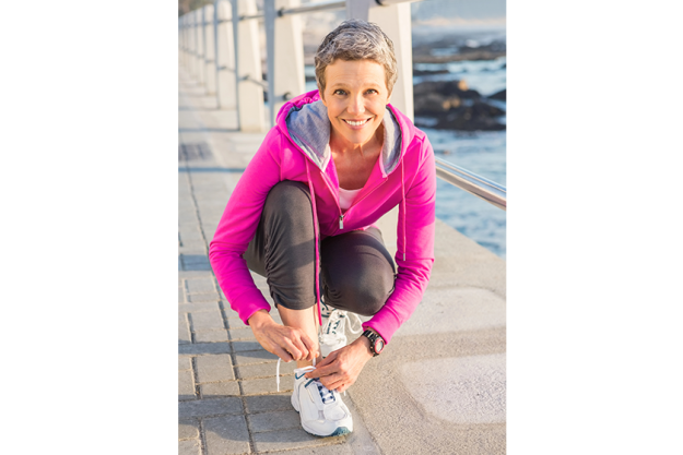 Woman tying her shoelace Woman tying her shoelace