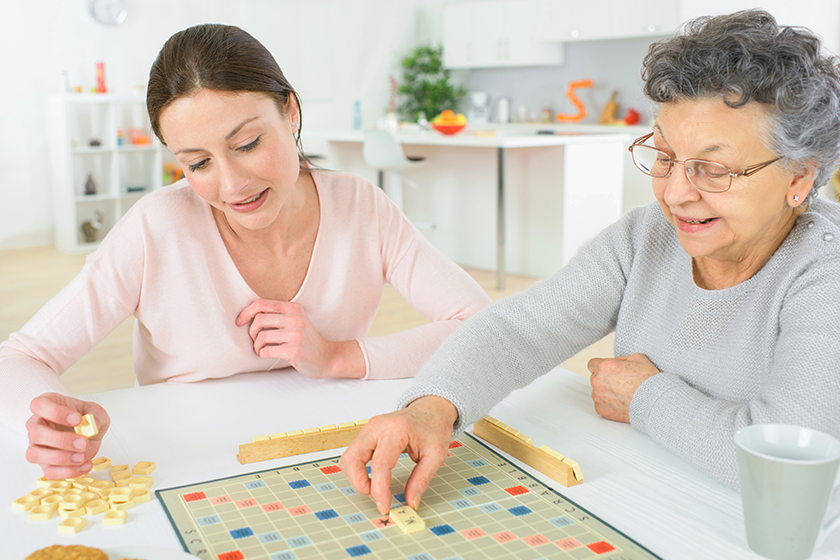 elderly woman playing a board game elderly woman playing a board game