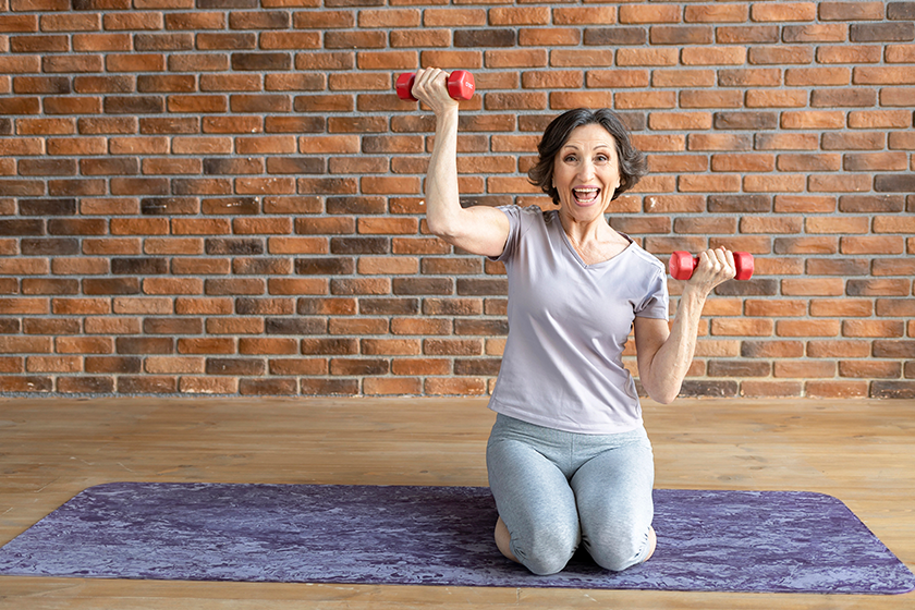 happy elderly athletic woman dumbbells sitting fitness mat happy elderly athletic woman dumbbells sitting fitness mat