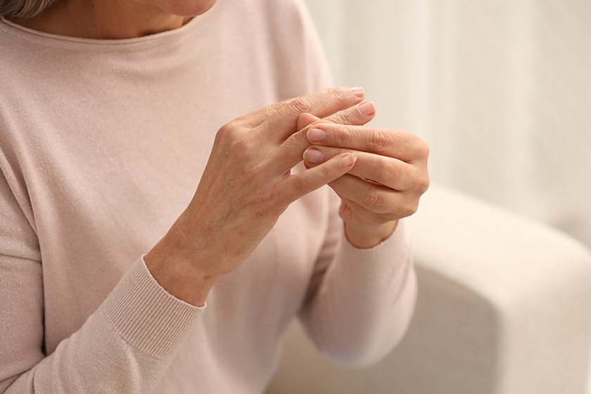 mature woman suffering pain hand