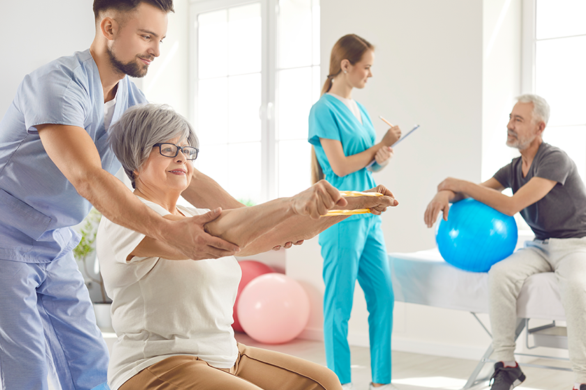 nurse helping senior smiling woman sport stretching exercises nurse helping senior smiling woman sport stretching exercises