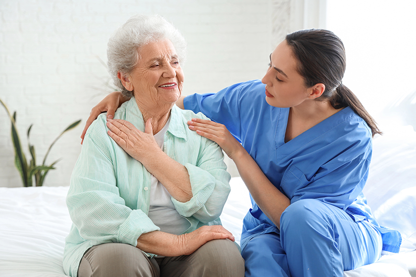 physical therapist hugging senior woman physical therapist hugging senior woman