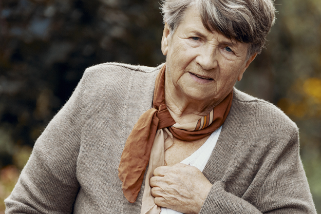 senior woman having a heart attack