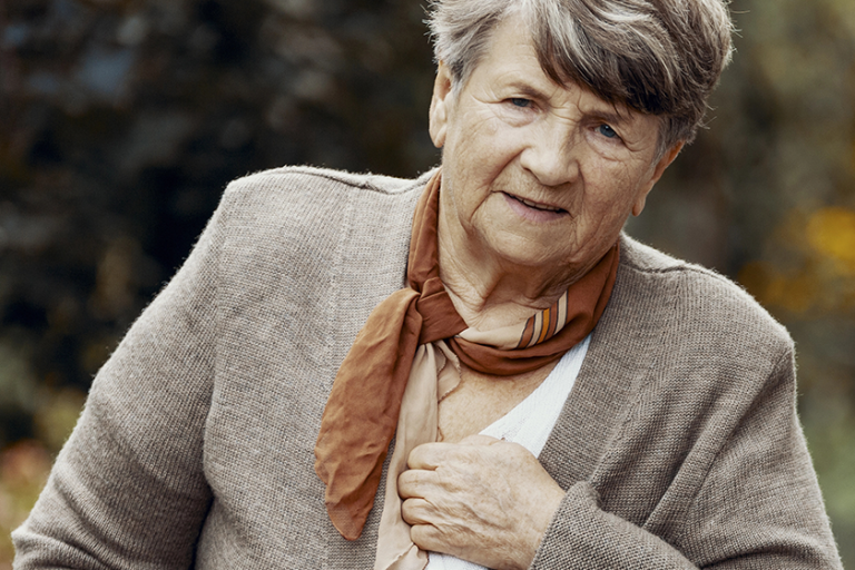 senior woman having a heart attack senior woman having a heart attack