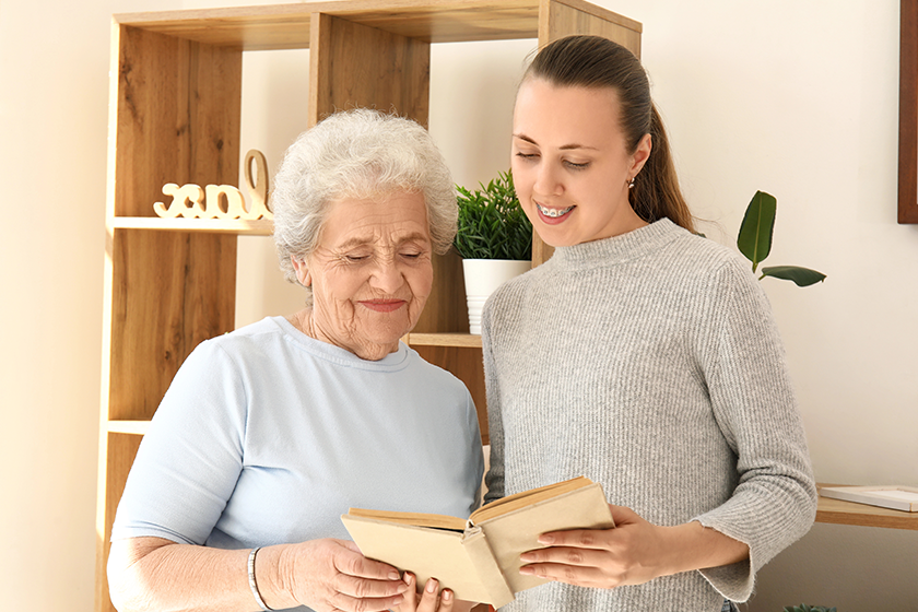 senior woman her granddaughter reading book