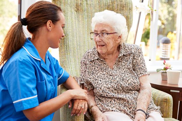 senior woman sitting chair talking nurse
