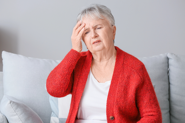 senior woman suffering from headache senior woman suffering from headache