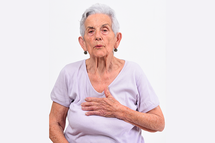 senior woman with hand to the heart for a scare senior woman with hand to the heart for a scare