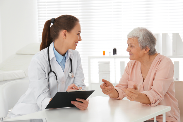 doctor examining senior patient