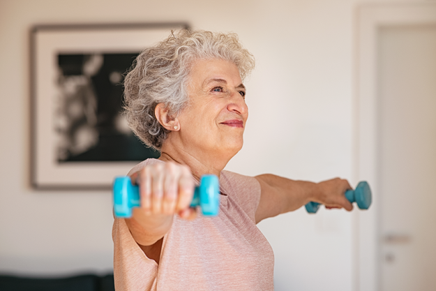 senior woman lifting weights working out