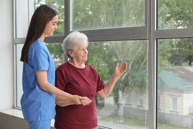 young nurse senior woman holding hands