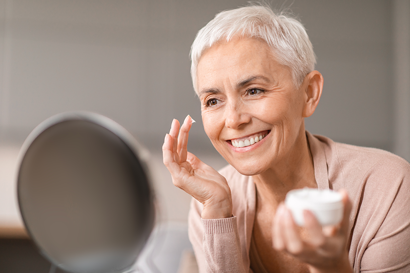 gorgeous mature woman applying facial moisturizer gorgeous mature woman applying facial moisturizer