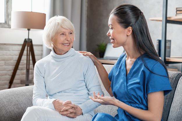 nurse assisting elderly woman