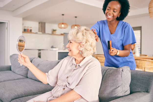 caregiver brush hair senior woman caregiver brush hair senior woman