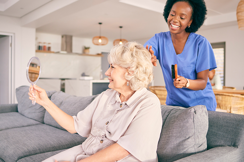 caregiver brush hair senior woman