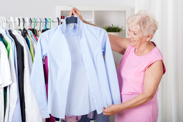 elderly woman choosing an outfit elderly woman choosing an outfit