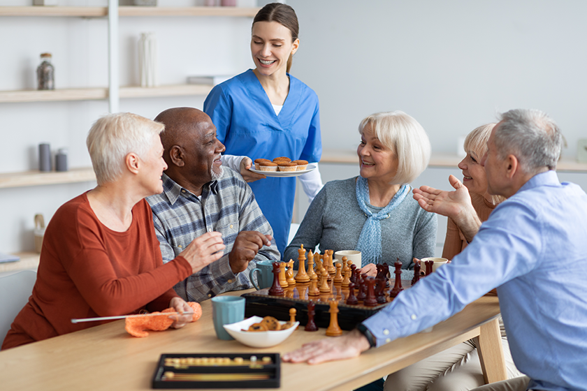 friendly nurse holding plate with cupcakes