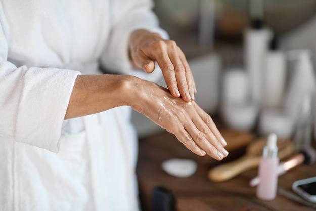 dry skin treatments mature woman applying anti aging serum