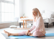 morning mature woman laptop practicing yoga