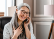 pleased middle aged white woman talking on phone