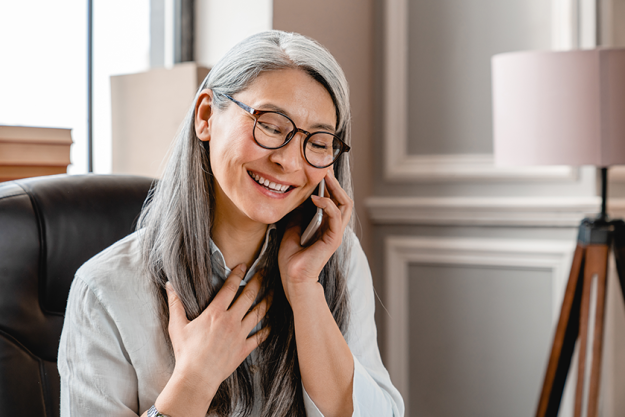 pleased middle aged white woman talking on phone