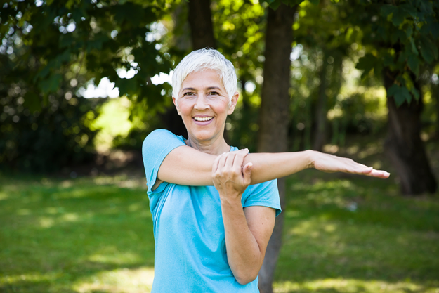 senior woman exercising tretching arm